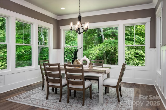 7703 Juniper Ln, Denver, NC 28037 - dining space with a decorative wall, a chandelier, dark wood-style flooring, a wainscoted wall, and ornamental molding