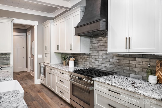 7703 Juniper Ln, Denver, NC 28037 - kitchen with appliances with stainless steel finishes, custom exhaust hood, decorative backsplash, white cabinets, and ornamental molding