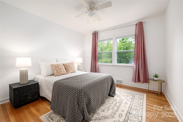 12 Canterbury Rd, Asheville, NC 28805 - bedroom with light wood-type flooring, a ceiling fan, and baseboards