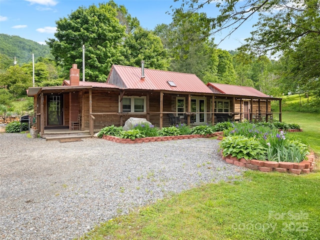 161 Moody Mountain Rd, Burnsville, NC 28714 - view of front of property with a chimney, metal roof, and a front lawn
