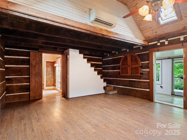 161 Moody Mountain Rd, Burnsville, NC 28714 - unfurnished living room with a wall mounted air conditioner, ceiling fan, wood walls, wood ceiling, and wood finished floors
