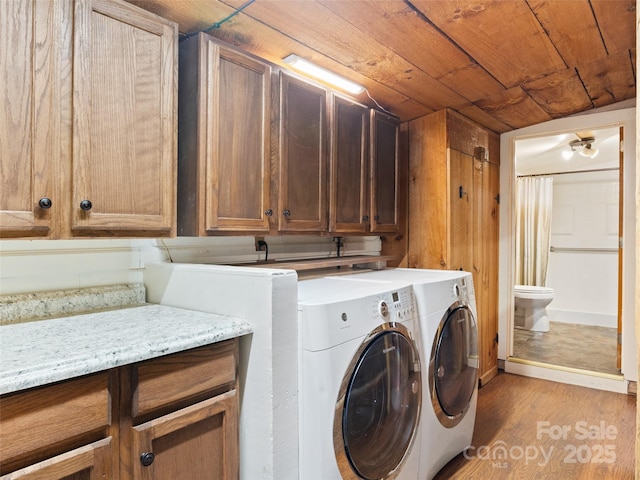 161 Moody Mountain Rd, Burnsville, NC 28714 - clothes washing area featuring cabinet space, washer and clothes dryer, light wood-style flooring, and wood ceiling