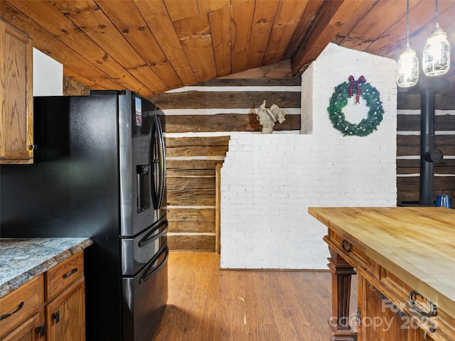 161 Moody Mountain Rd, Burnsville, NC 28714 - kitchen featuring black fridge with ice dispenser, vaulted ceiling, brown cabinets, dark wood finished floors, and wood ceiling