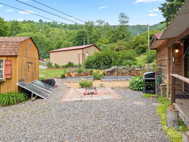 161 Moody Mountain Rd, Burnsville, NC 28714 - view of yard with an outdoor structure, a storage unit, and a view of trees