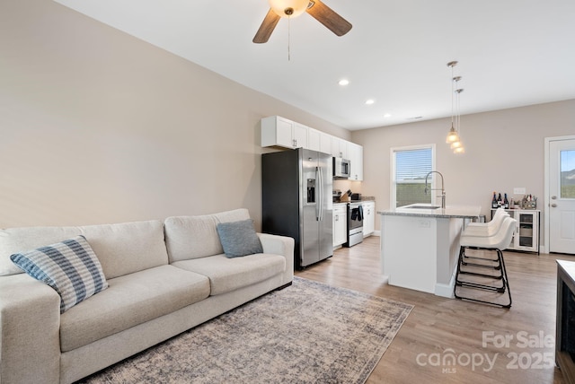 2242 Bear Creek Rd, Leicester, NC 28748 - living room with light wood-style floors, ceiling fan, recessed lighting, and baseboards