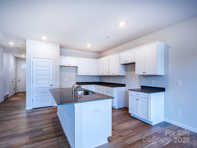 2541 Ruby Dixon Crossing Dr Unit 18, Gastonia, NC 28056 - kitchen with dark countertops, a sink, white cabinetry, dark wood-style floors, and recessed lighting