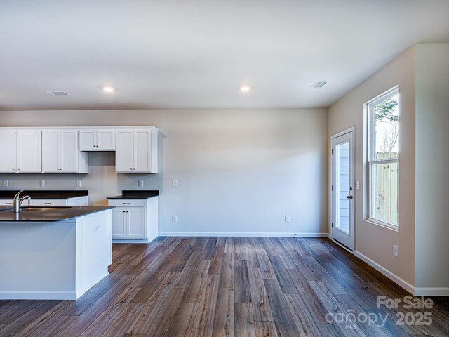 2541 Ruby Dixon Crossing Dr Unit 18, Gastonia, NC 28056 - kitchen with a sink, dark countertops, dark wood-type flooring, white cabinetry, and baseboards