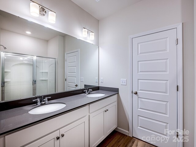 2541 Ruby Dixon Crossing Dr Unit 18, Gastonia, NC 28056 - bathroom with double vanity, wood finished floors, a stall shower, and baseboards