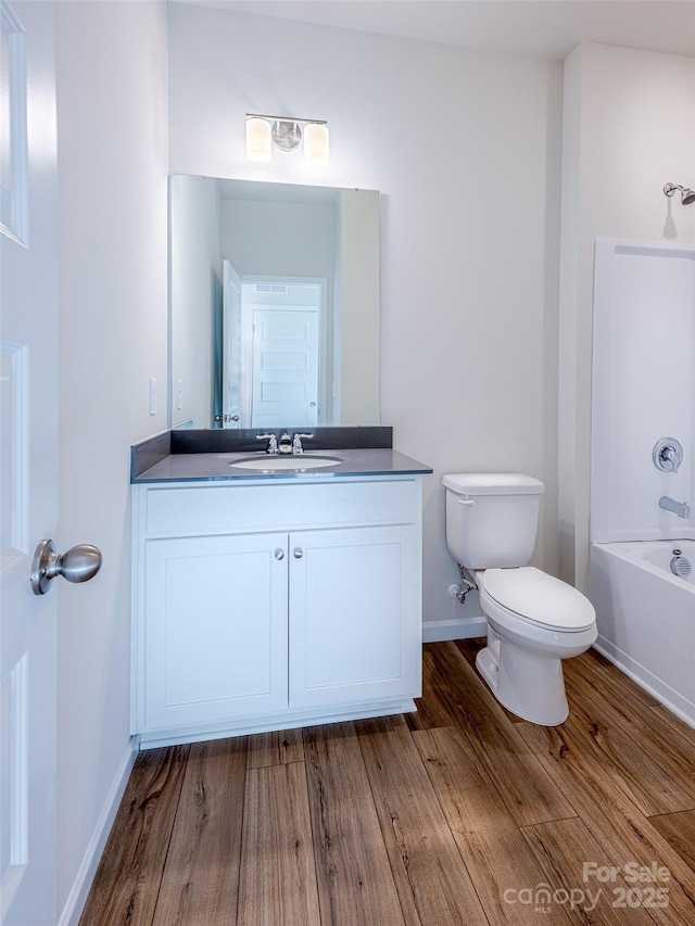 2541 Ruby Dixon Crossing Dr Unit 18, Gastonia, NC 28056 - bathroom featuring toilet, vanity, wood finished floors, and baseboards