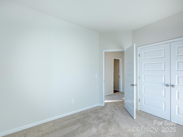 2541 Ruby Dixon Crossing Dr Unit 18, Gastonia, NC 28056 - unfurnished bedroom with light carpet, baseboards, and a closet