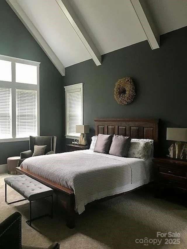 bedroom featuring beam ceiling, carpet flooring, multiple windows, and high vaulted ceiling