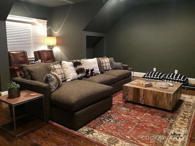 cinema room featuring dark wood-style floors and baseboards