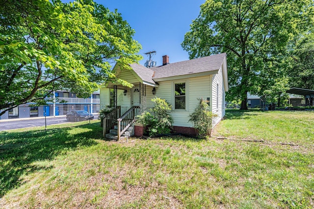 3042 N Oxford St, Claremont, NC 28610 - view of front facade with a chimney and roof with shingles
