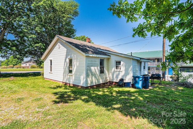 3042 N Oxford St, Claremont, NC 28610 - view of side of home with a chimney and roof with shingles