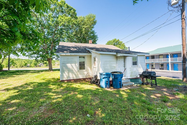3042 N Oxford St, Claremont, NC 28610 - rear view of property featuring roof with shingles and a chimney