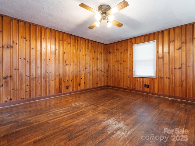876 Stowe Ln, Gastonia, NC 28056 - unfurnished room featuring wood-type flooring, ceiling fan, and wooden walls