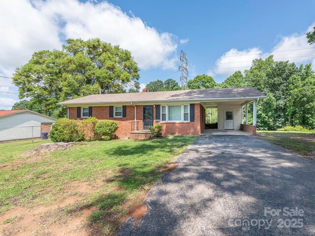 876 Stowe Ln, Gastonia, NC 28056 - ranch-style house featuring brick siding, driveway, a front lawn, a chimney, and a carport