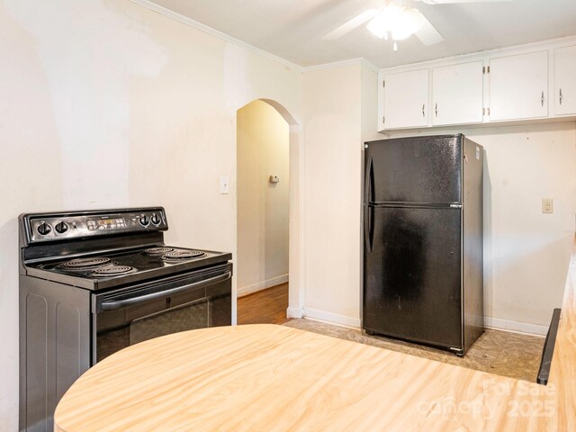 876 Stowe Ln, Gastonia, NC 28056 - kitchen with black appliances, arched walkways, a ceiling fan, white cabinetry, and baseboards