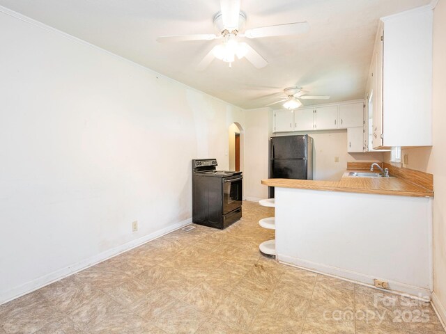 876 Stowe Ln, Gastonia, NC 28056 - kitchen with black appliances, a sink, a ceiling fan, arched walkways, and white cabinets