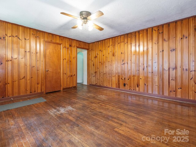 876 Stowe Ln, Gastonia, NC 28056 - empty room with wood finished floors, ceiling fan, and wooden walls