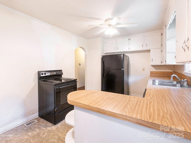 876 Stowe Ln, Gastonia, NC 28056 - kitchen featuring black appliances, a sink, arched walkways, a peninsula, and white cabinetry