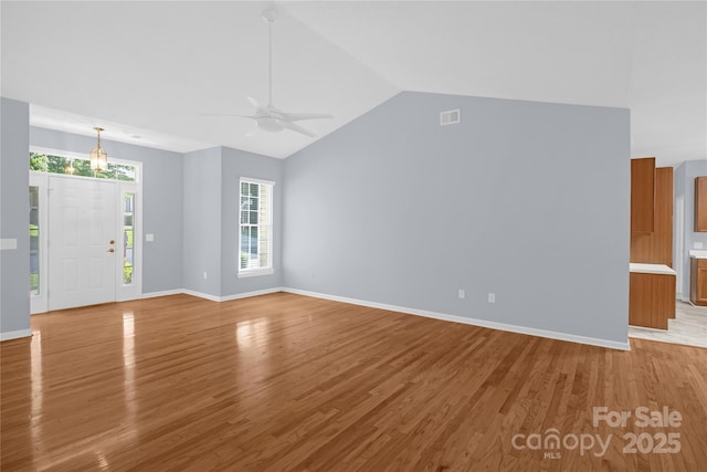 4467 Antelope Ln, Charlotte, NC 28269 - unfurnished living room with light wood-type flooring, lofted ceiling, and a ceiling fan