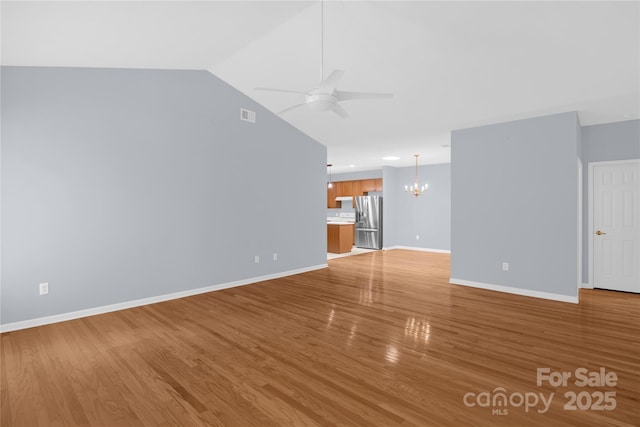 4467 Antelope Ln, Charlotte, NC 28269 - unfurnished living room with a chandelier, a ceiling fan, light wood-style floors, and lofted ceiling