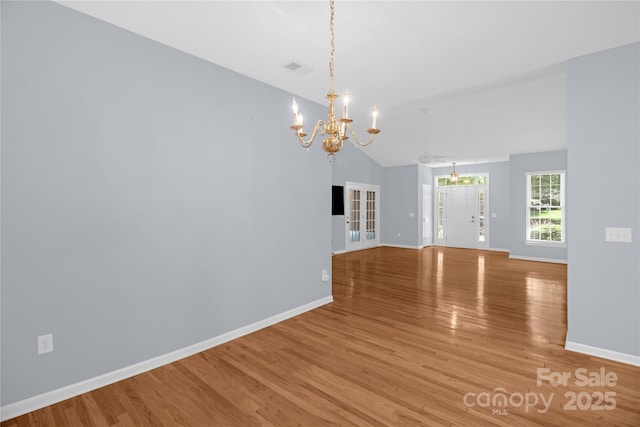4467 Antelope Ln, Charlotte, NC 28269 - unfurnished dining area with a chandelier, wood finished floors, and lofted ceiling