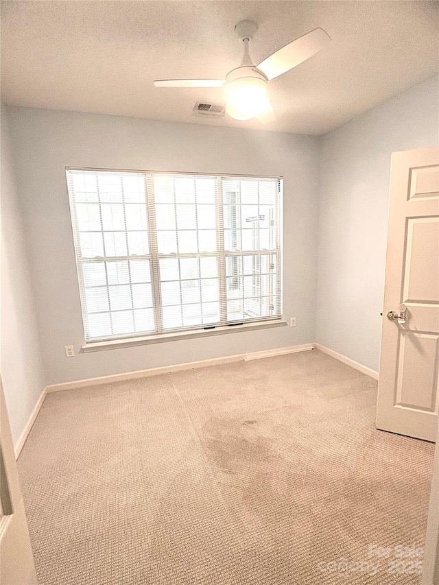4467 Antelope Ln, Charlotte, NC 28269 - unfurnished room with healthy amount of natural light, ceiling fan, and light colored carpet