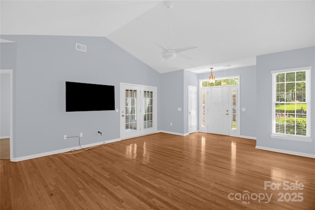 4467 Antelope Ln, Charlotte, NC 28269 - unfurnished living room featuring wood finished floors, lofted ceiling, and a ceiling fan