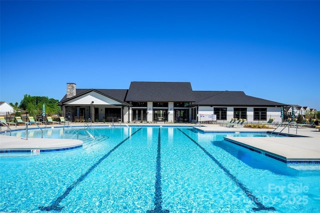 community pool with fence and a patio area