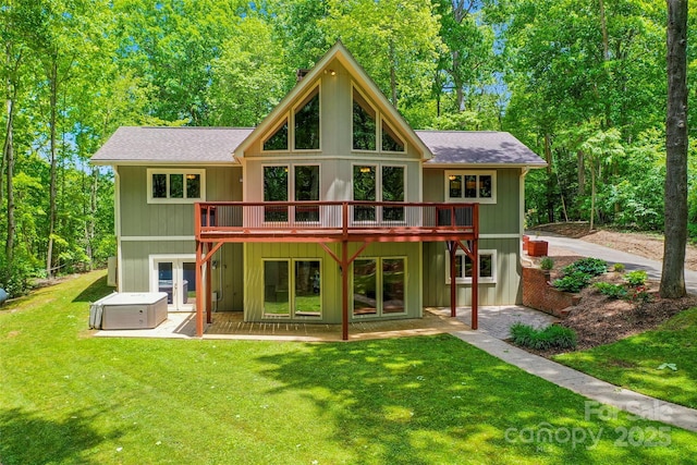 82 Sunburst Dr, Waynesville, NC 28786 - back of house featuring a hot tub, a lawn, a deck, roof with shingles, and a patio area