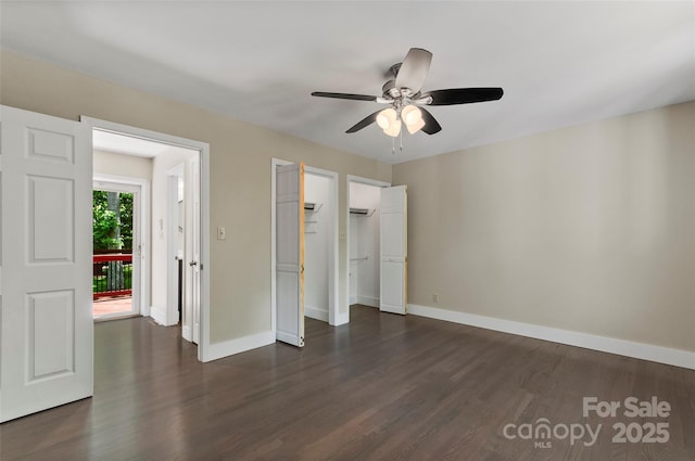 82 Sunburst Dr, Waynesville, NC 28786 - unfurnished bedroom with dark wood-style flooring, baseboards, ceiling fan, and a closet
