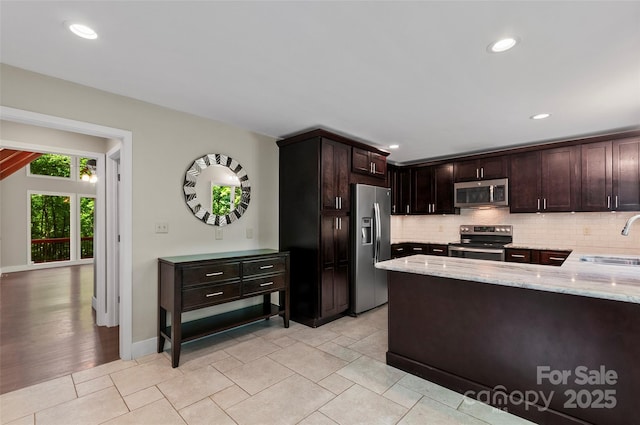82 Sunburst Dr, Waynesville, NC 28786 - kitchen with appliances with stainless steel finishes, light stone counters, a sink, decorative backsplash, and recessed lighting