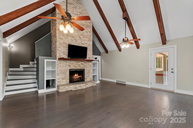 82 Sunburst Dr, Waynesville, NC 28786 - unfurnished living room with a ceiling fan, beam ceiling, a fireplace, wood finished floors, and high vaulted ceiling