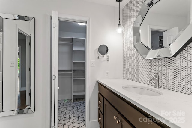 82 Sunburst Dr, Waynesville, NC 28786 - bathroom featuring backsplash, vanity, and a walk in closet