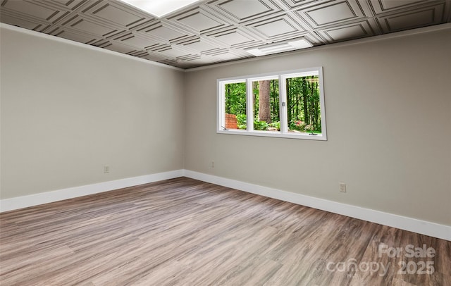 82 Sunburst Dr, Waynesville, NC 28786 - spare room with an ornate ceiling, baseboards, and light wood-style floors