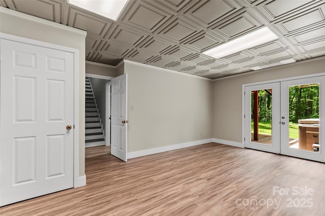 82 Sunburst Dr, Waynesville, NC 28786 - empty room featuring an ornate ceiling, french doors, baseboards, light wood-type flooring, and stairway