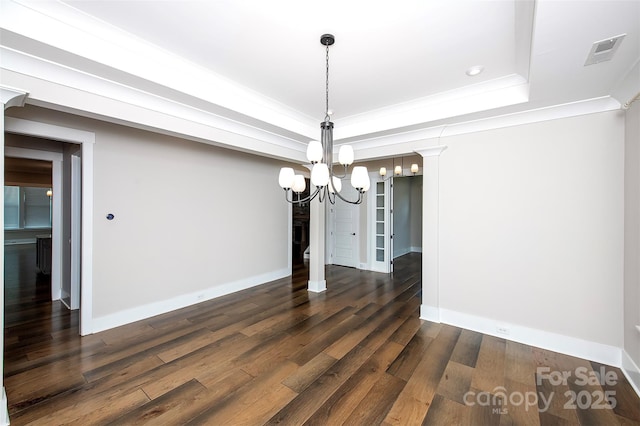720 Cavesson Way, Monroe, NC 28110 - unfurnished dining area featuring a chandelier, a raised ceiling, dark wood-type flooring, and ornamental molding