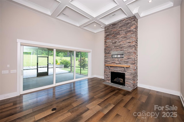 720 Cavesson Way, Monroe, NC 28110 - unfurnished living room with wood finished floors, beam ceiling, a fireplace, a towering ceiling, and coffered ceiling