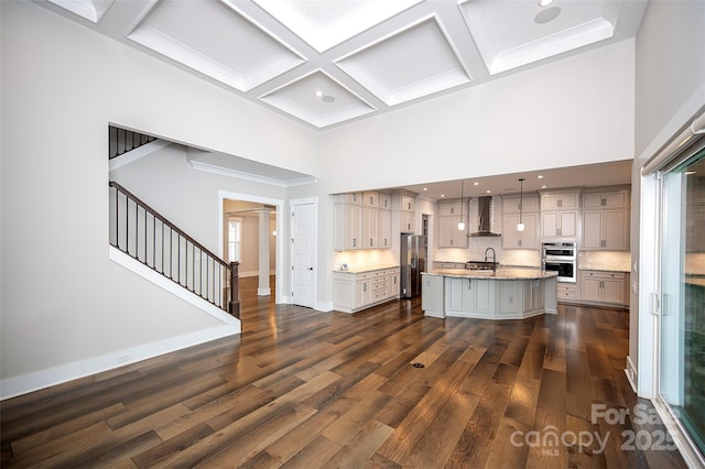 720 Cavesson Way, Monroe, NC 28110 - kitchen with stainless steel appliances, wall chimney range hood, a towering ceiling, coffered ceiling, and dark wood finished floors