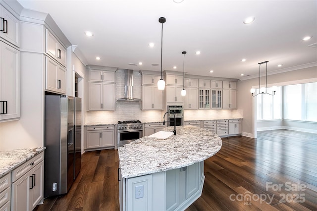 720 Cavesson Way, Monroe, NC 28110 - kitchen with wall chimney exhaust hood, appliances with stainless steel finishes, an island with sink, backsplash, and ornamental molding