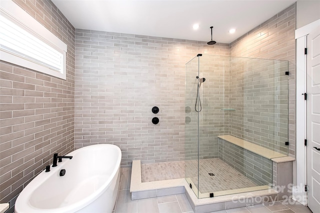 720 Cavesson Way, Monroe, NC 28110 - full bathroom with a shower stall, a freestanding bath, tile patterned flooring, recessed lighting, and tile walls