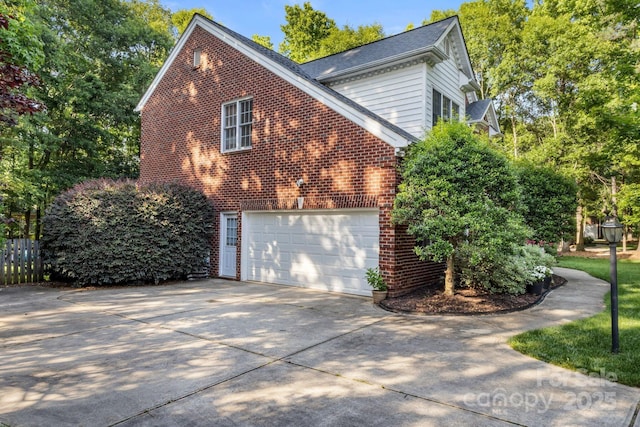 4389 Enchantment Cove Ln, Charlotte, NC 28216 - view of property exterior with concrete driveway and brick siding