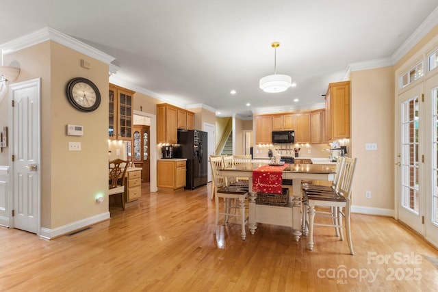 4389 Enchantment Cove Ln, Charlotte, NC 28216 - dining space featuring light wood finished floors, ornamental molding, baseboards, and recessed lighting