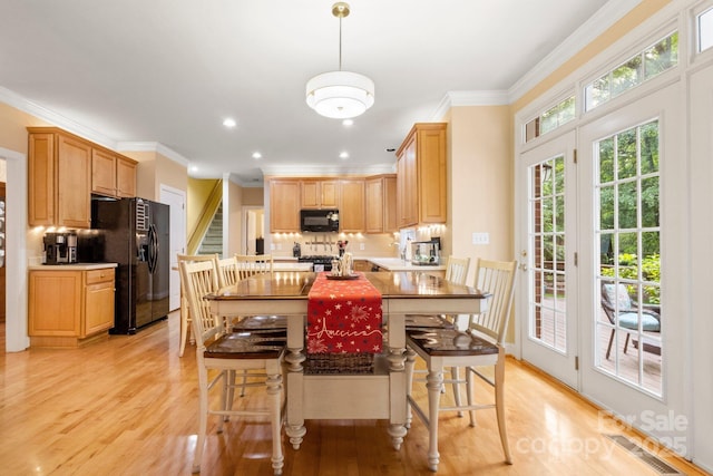 4389 Enchantment Cove Ln, Charlotte, NC 28216 - kitchen with black appliances, tasteful backsplash, light wood-type flooring, ornamental molding, and recessed lighting