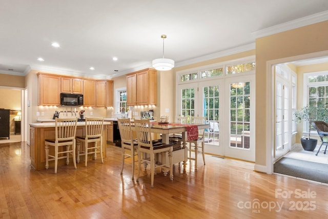 4389 Enchantment Cove Ln, Charlotte, NC 28216 - dining area with light wood finished floors, crown molding, and recessed lighting
