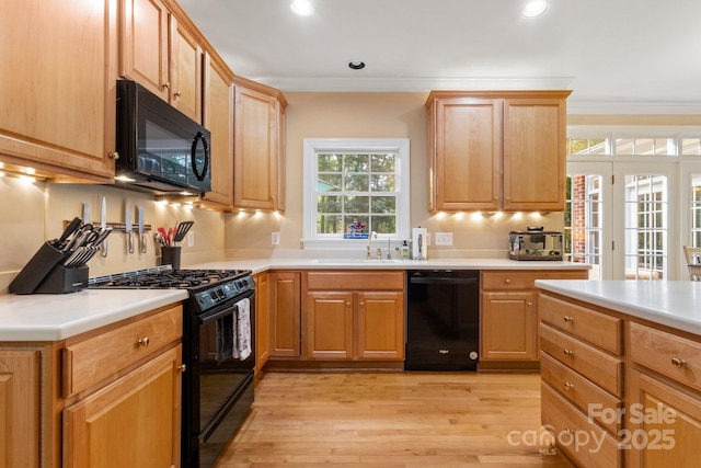 4389 Enchantment Cove Ln, Charlotte, NC 28216 - kitchen with black appliances, light countertops, light wood finished floors, recessed lighting, and crown molding