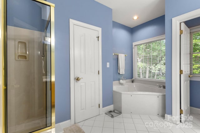 4389 Enchantment Cove Ln, Charlotte, NC 28216 - bathroom with baseboards, a garden tub, a shower stall, and tile patterned flooring