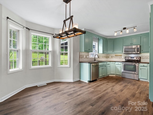 730 Cove Rd, Gastonia, NC 28052 - kitchen with appliances with stainless steel finishes, green cabinetry, decorative backsplash, and dark wood-style flooring